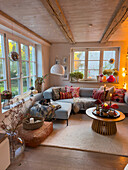 Cosy living room with light blue corner sofa and autumnal decorations