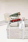 Gift in newspaper with small VW bus and Christmas tree