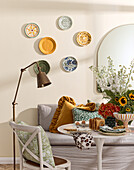 Dining area with decorative wall plates and bouquet of sunflowers