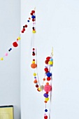 Colourful garland made of wool pom-poms