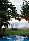 A view of the infinity pool and Gulf of Thailand at Knai Bang Chatt Hotel., Kep, Cambodia/Outdoor Canopy Bed