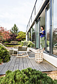 woman at the terrace door with a cup, coodo modern way of living, modern architecture in Hamburg, north Germany, Germany