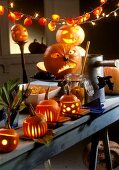 Table laid for Halloween with illuminated pumpkins