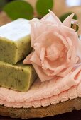 Herb and lavender soap and pink rose on hand towel