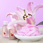 Pink lily, bath puff and bath products