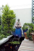 Zen garden with pond and Buddha figure