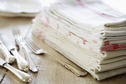 Silvery cutlery and tea towels
