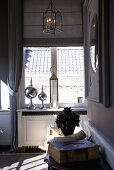 Candle lantern and stainless steel ornaments on windowsill