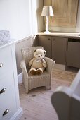 Teddy bear sitting on child's wicker chair