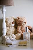 Two teddy bears and baby shoes