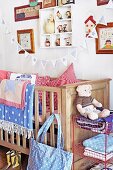 Nursery with wooden cot, blankets, cushions & bunting
