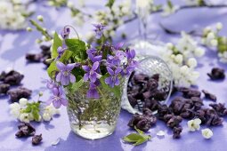 Violets in glass, candied violets and sprigs of blossom