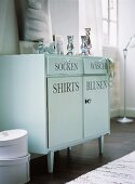 Cabinet with lettering in bedroom