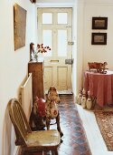 Hallway with chequered tiled floor decorated with antique toys