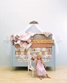 Little girl sitting in front of bed stacked high with mattresses