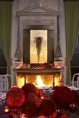 A festively decorated table in front of a fireplace