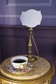 Cup of coffee on occasional table in Château de la Verrerie (France)