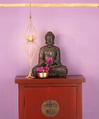 Buddha figure on cupboard