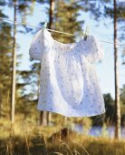 A girl's dress hanging on a washing line