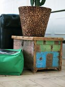 Plant pot with a circular pattern on a rustic wooden chest