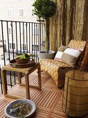 Cozy balcony corner with a wooden side table and basket chair on a wooden floor