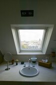 Built in vanity with bathroom accessories under a skylight