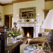 Crackling fire in a fireplace in a living room (country home style decor)