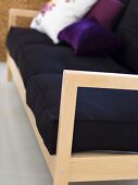 Light wooden sofa frame with black upholstery