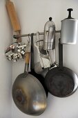 Cookware hanging from steel bar