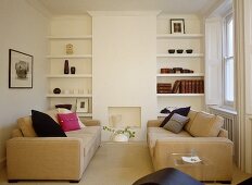 Pair of upholstered sofas facing each other in front of fireplace with built in shelving