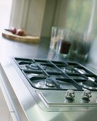 A gas hob set into a stainless steel work surface