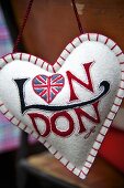 A hanging heart-shaped cushion with the Union flag