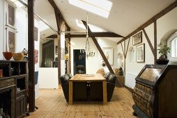 A living room in a converted attic with wooden beams