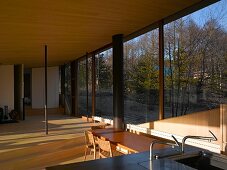 An open living room in a newly built house with a glass facade and a view