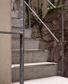 Concrete steps with a metal banister outside