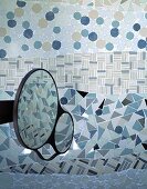 Patchwork type tile design on a bathroom wall and movable makeup mirror