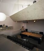 View of a pool table in a living area underneath a mezzanine