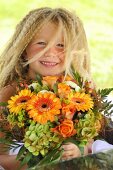 Blond girl with bouquet of flowers
