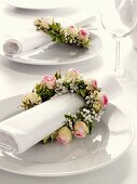 Napkin wreaths of roses and baby's breath