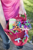 Woman holding basket of decorations for a garden party