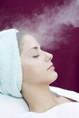 Young woman having steam treatment (spa treatment)