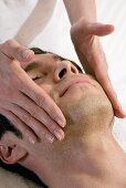 Man receiving facial massage