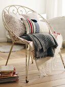 Cushions and blankets on metal chair