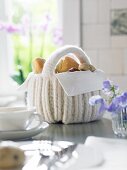 A white crocheted bread basket