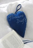 Heart-shaped, scented sachet made from blue fabric
