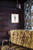 Unheated room with wooden walls & antique sofa