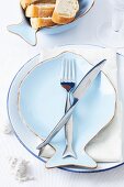 A place setting with fish-shaped crockery and cutlery