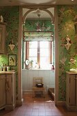 Green wallpaper with pattern of flowers & birds in bathroom