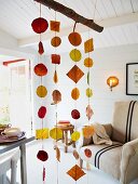 Interior decorated with autumnal mobile made from autumn leaves