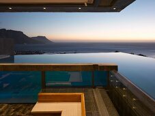 View of the ocean from the terrace of a contemporary home at dusk
